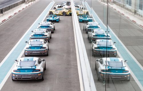 Aston Martins in one row in the pit lane